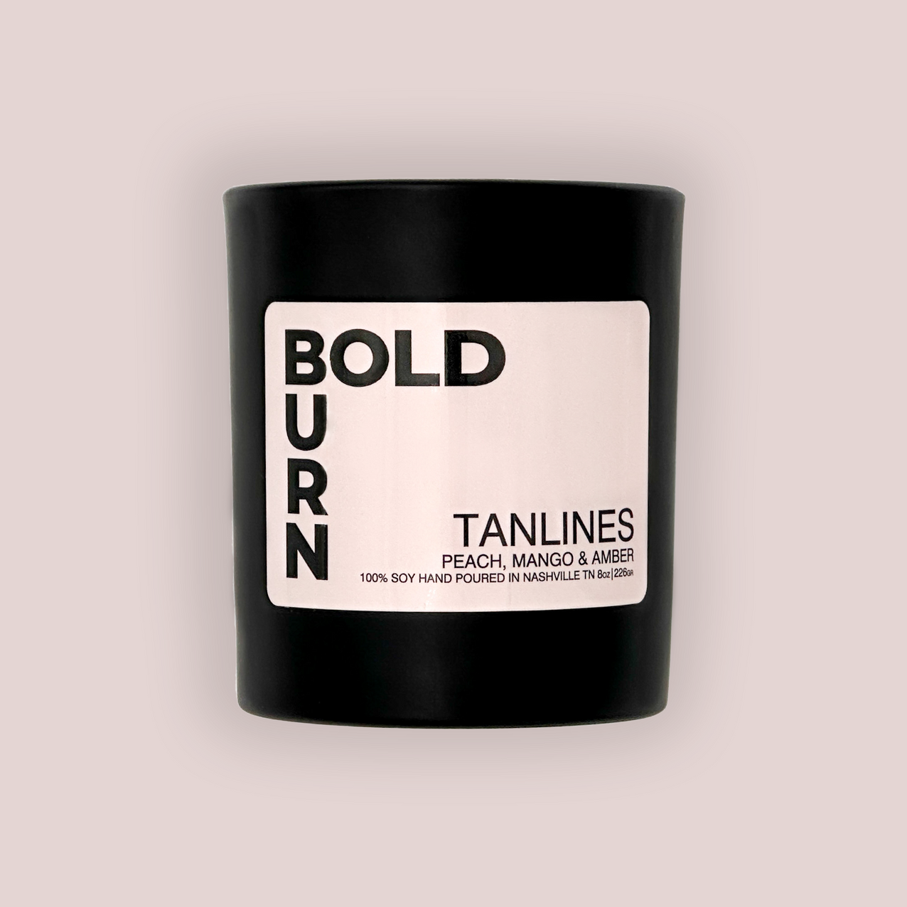 Tanlines two-wick black candle with white label reading Bold Burn Tanlines Peach, Mango, and Amber on white background